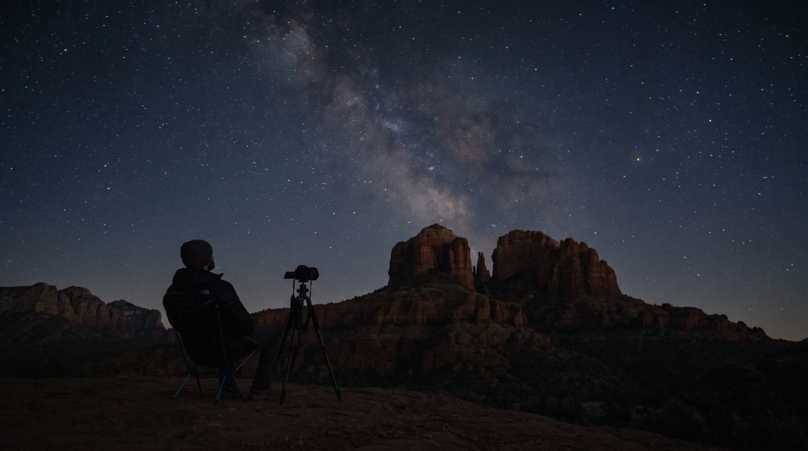 The Milky Way arcing over a red sandstone butte during Sedona stargazing, with no city glow on the horizon