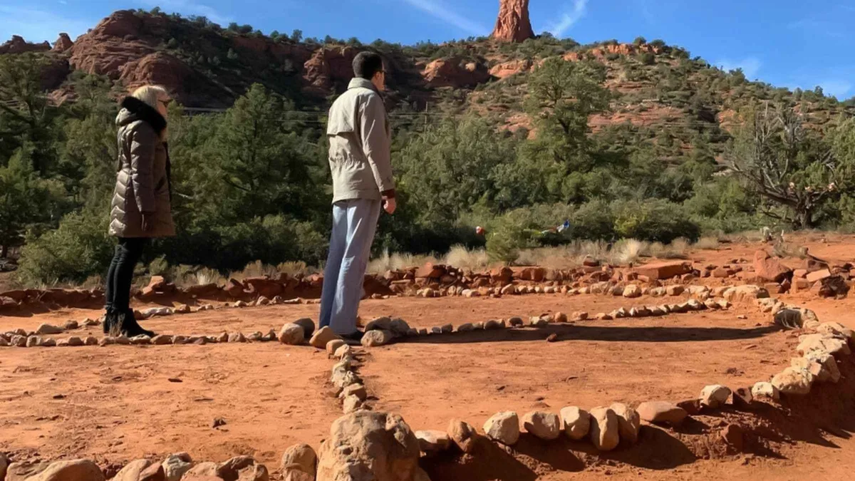 Guide pointing out a red rock vortex site on a Sedona vortex jeep tour