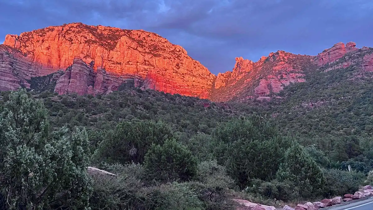 Riders on e-bikes at a red rock vista during a Sedona sunset tour
